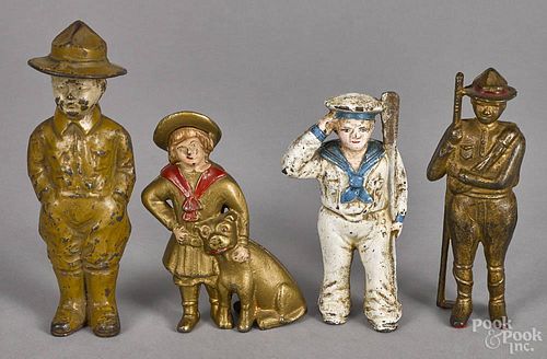 Four cast iron still banks, to include a doughboy, a Buster Brown and Tige, a sailor, and a boy scout