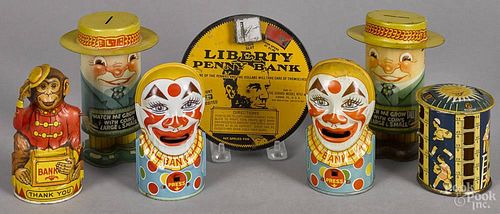 Seven tin lithograph still banks, to include Chein monkey and two clowns, two Watch me Grow