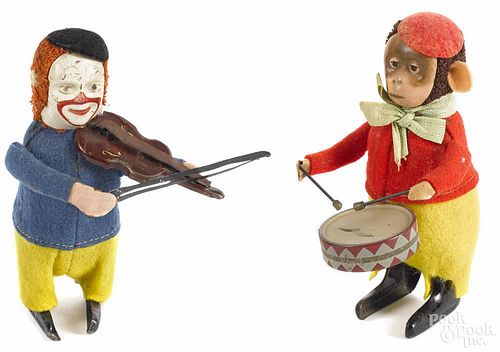 Two Schuco wind-up toys, 20th c., to include a clown playing the violin and a monkey playing a drum