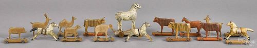 Twelve carved and painted animal pull toys, ca. 1900, together with three stick leg running horses