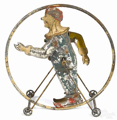 German painted tin clockwork clown acrobat in a hoop, 6 1/4'' h.