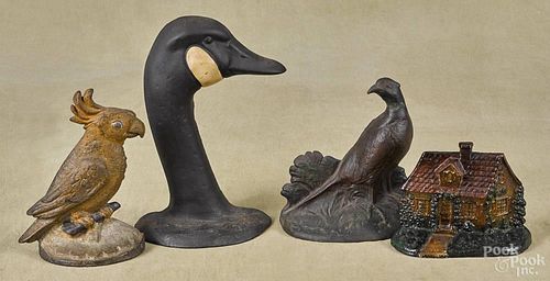 Four cast iron doorstops, early/mid 20th c., to include a pheasant, a cabin, a cockatoo, and a goose