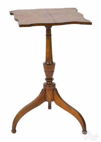New England cherry candlestand, 19th c., with a shaped top, 27'' h., 17'' w.