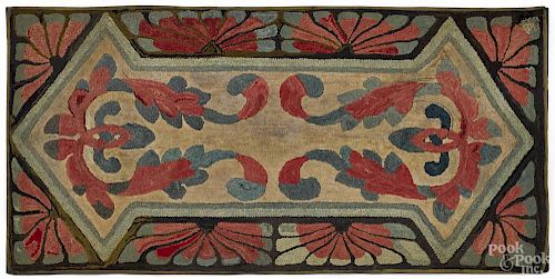 Hooked rug, ca. 1900, with central lyres on a white field with a shell border, 28 1/2'' x 58''.