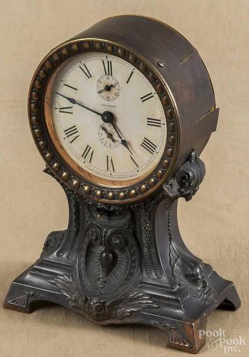 Oak gingerbread clock, ca. 1900, 24'' h., together with a Seth Thomas alarm clock with a bronzed case