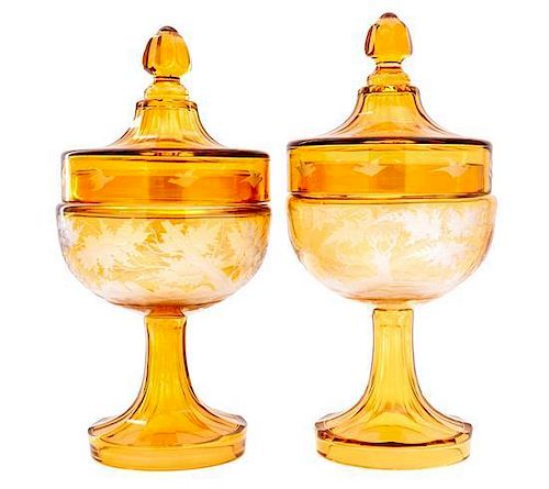 A Pair of Bohemian Etched Amber Glass Covered Urns Height 11 1/4 inches.