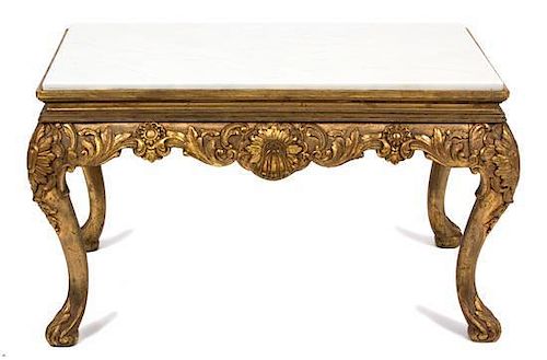 An Italian Louis XV Style Giltwood Carved Low Table Height 18 x width 31 1/2 x depth 31 1/2 inches.