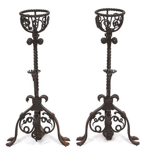 A Pair of Jacobean Style Wrought Iron Fire Dogs Height 29 1/2 inches.