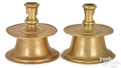 Two similar brass capstan candlesticks, ca. 1600
