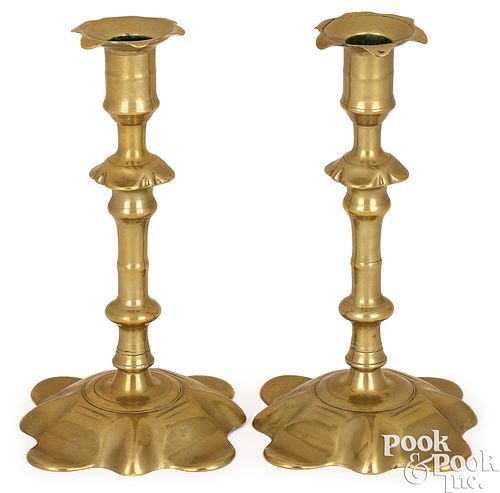 A pair of Georgian brass petal base candlesticks