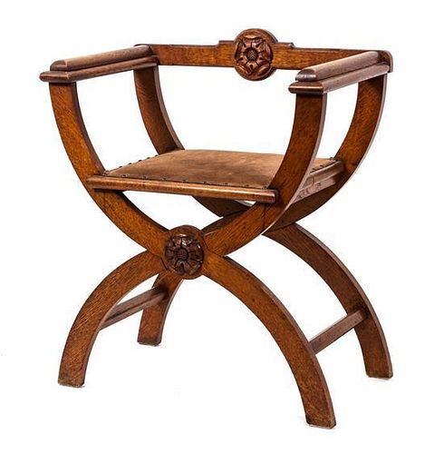 An English Arts & Crafts Carved Oak Savanarola Chair Height 31 1/2 inches.