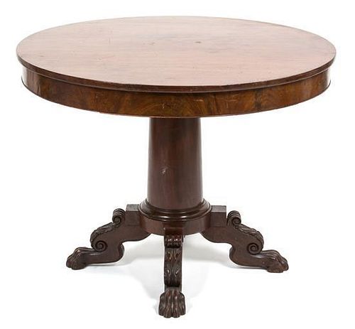 An American Empire Mahogany Tilt Top Table Height 27 1/2 inches x diameter 36 1/2 inches.