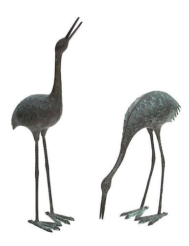 A Pair of Patinated Metal Standing Cranes Height of taller 38 1/2 inches.
