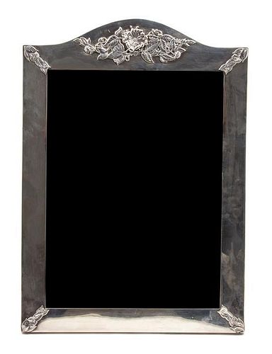 An English Silver Framed Easel Back Mirror, Asprey & Company, having a shaped crest with floral decoration.