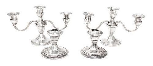 Two Pairs of Weighted Sterling Candlesticks, Various Makers, comprising a pair of three-light candlesticks and a pair of sing