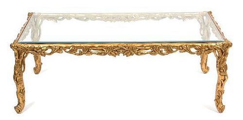 A Carved Giltwood Rectangular Glass Top Table Height 17 1/2 x width 50 3/4 x depth 31 inches.