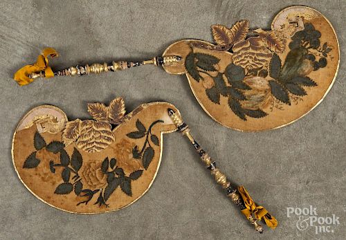 Pair of oil on velvet face screens, 19th c., with turned and gilt decorated handles, 18 1/4'' l.