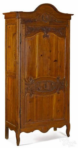 French pine wardrobe, 19th c., with carved doors and a later fitted interior, 90'' h., 40'' w.