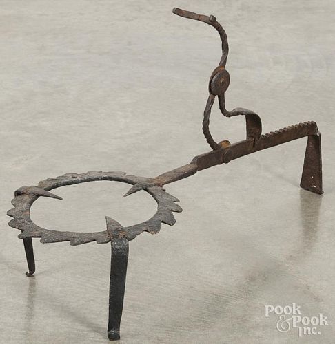 Wrought iron trivet, ca. 1800, with an adjustable ladle rest, 25'' l.