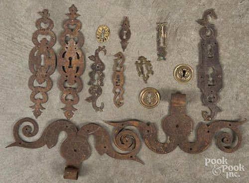 Wrought iron and brass, to include a pair of ram's horn hinges, escutcheons, etc.