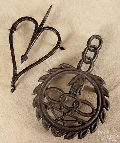 Wrought iron heart-form trivet, 19th c., with a snake head terminal and spade feet, 7'' l.