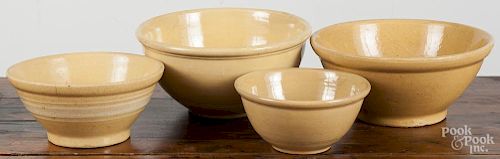 Four yellowware bowls, largest - 5'' h., 10 1/4'' dia.