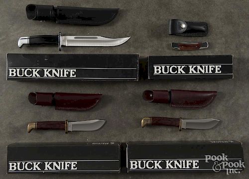 Seven cased Buck knives.