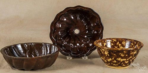 Two redware Turk's head molds, 19th c., 8'' dia. and 7 1/2'' dia., together with a Bennington bowl