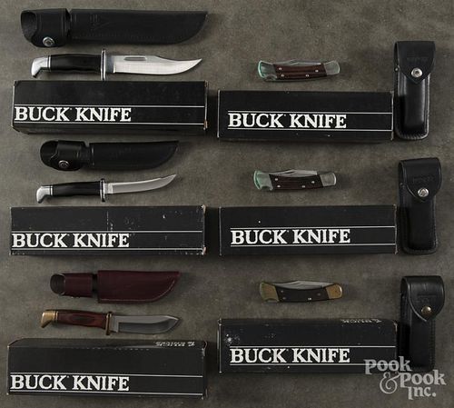 Ten Buck Knives with sheaths and boxes.
