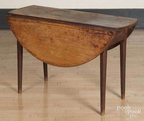 Pine drop leaf table, early 19th c., the base retaining an old red surface, 28'' h., 16 1/2'' w.