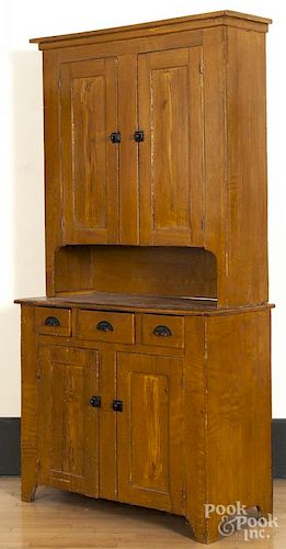 Pennsylvania painted poplar two-part cupboard, 19th c., retaining an old ochre grained surface