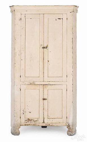 Pennsylvania painted pine corner cupboard, 19th c., retaining an old ivory surface, 81'' h., 45'' w.