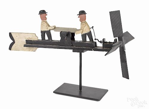 Painted pine whirligig, early 20th c., with two men sawing a log and wearing bowler hats, 21 3/4'' l.