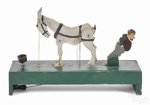 Carved and painted articulated kicking mule, early 20th c., 14'' w.