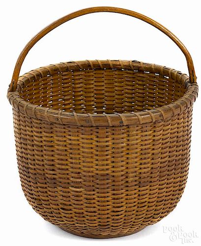 Nantucket lightship basket, mid 20th c., with a swing handle, 9 1/2'' h., 8 5/8'' dia.