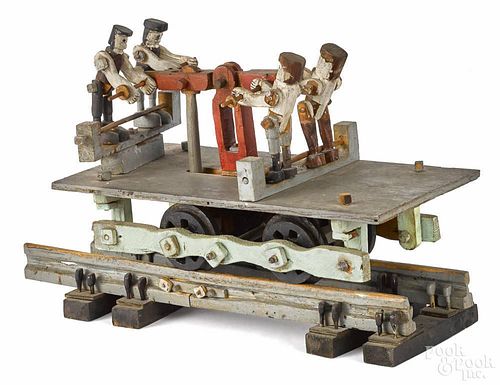 Carved and painted mechanical railroad handcar, early 20th c., with a small section of track