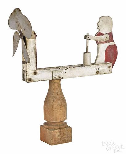 Carved and painted pine whirligig of a woman churning butter, early 20th c., 18 1/2'' l.