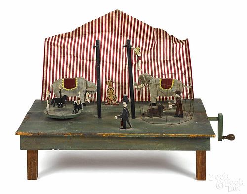 Painted and cutout mechanical circus, early 20th c., on a green platform base