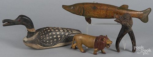 Three carved figures of a loon, fish, and lion, longest - 17'', together with a wild boar nutcracker.