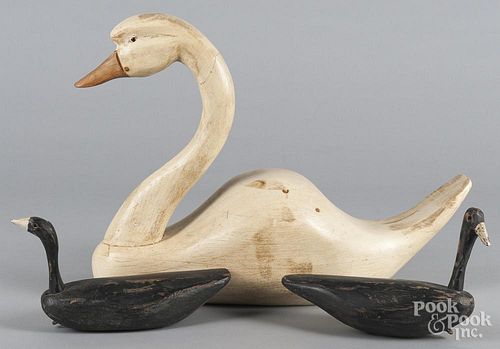 Carved and painted swan decoy, together with two ducks.