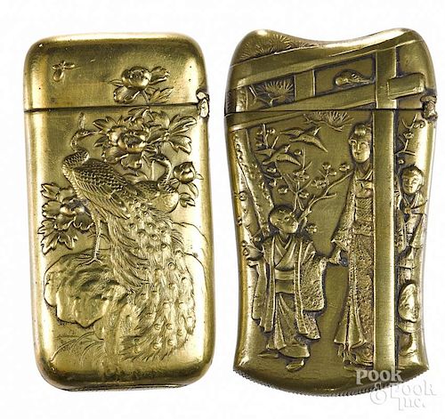Two embossed brass match vesta safes, one Japanese with a Geisha scene, 2 1/2'' h.