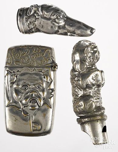 Three dog match vesta safes, to include a figural begging dog whistle, a figural sterling hound