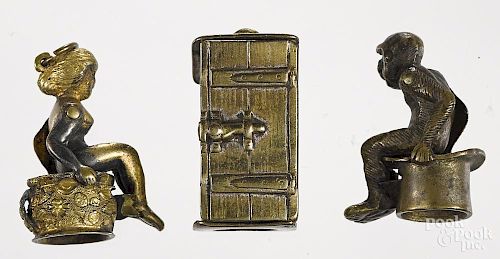 Three figural cigar cutters, to include a brass woman seated in an outhouse, 1 1/8'' h.