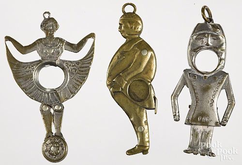 Three figural cigar cutters, to include a dancing woman, a gentleman, and a bellhop, tallest - 2''.