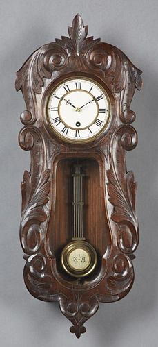 French Carved Walnut Wall Clock, late 19th c., the