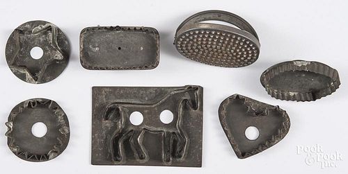 Seven tin cookie cutters, to include a horse, a heart, a star, etc.