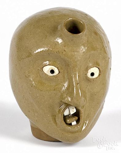 Stoneware face jug, signed Vance, together with a redware bank, signed A. Vince, 7'' h.