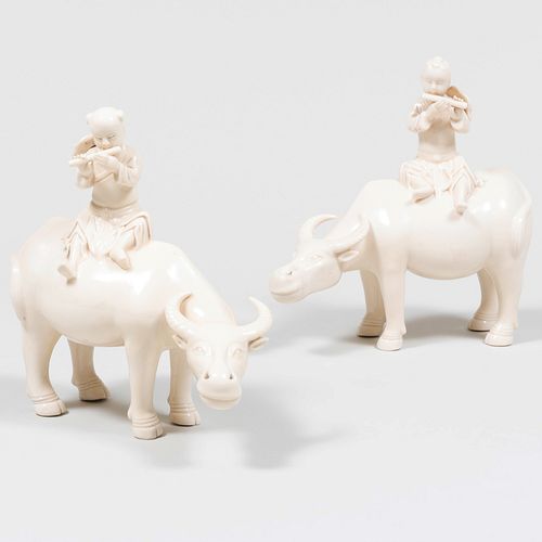 Pair of Chinese White Glazed Porcelain Figures of Boys Riding Buffalos