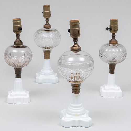 Group of Four Clear Glass Fluid Lamps