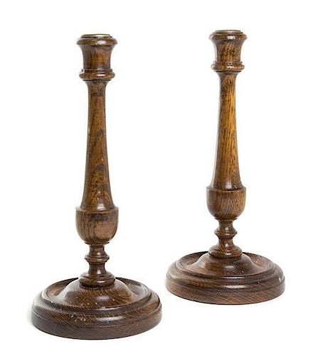 * A Pair of Turned Oak Candlesticks Height 12 inches.